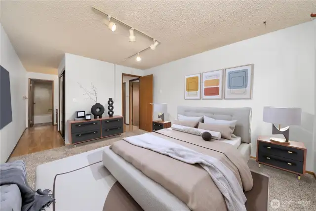 Generously sized primary bedroom with a private bath offers respite at the end of the day. Virtually staged.