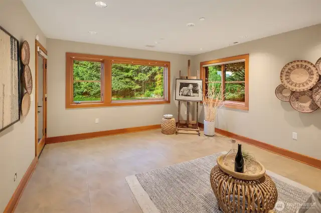 Lower level art studio, craft room, office or non conforming bedroom with full bath off and door to exterior of the home.