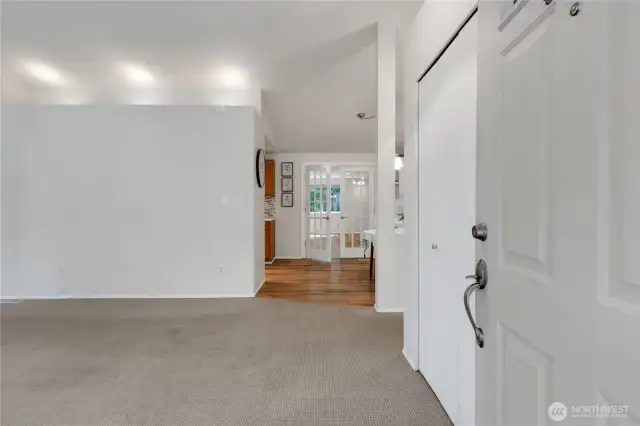 Step inside to a cozy living room with vaulted ceilings that create a bright, open feel.  French doors lead to a spacious great room, offering a perfect flow for entertaining and relaxing.