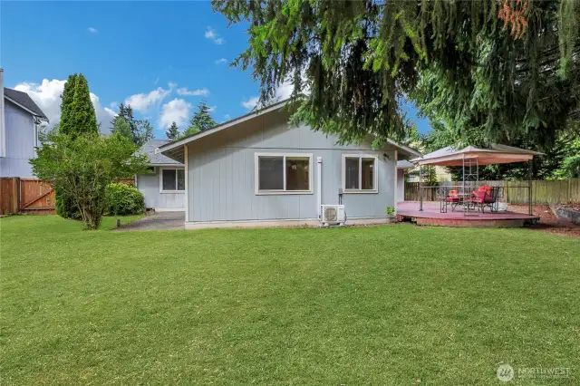 Back of the home offers convenient RV parking on the left side with a gate, perfect for your recreational vehicles or extra storage.  On the right , enjoy a spacious deck, alongside a cozy fire pit area. A fenced side yard with a gate provides secure access to the fron tof the home which adds convenience.