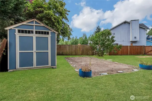 Storage shed sits beside a spacious, level area that once held a pool.  Now a blank canvas.  This yard has tons of room for garden, dog run, trampoline, or even another pool.  So much room to customize your outdoor space!
