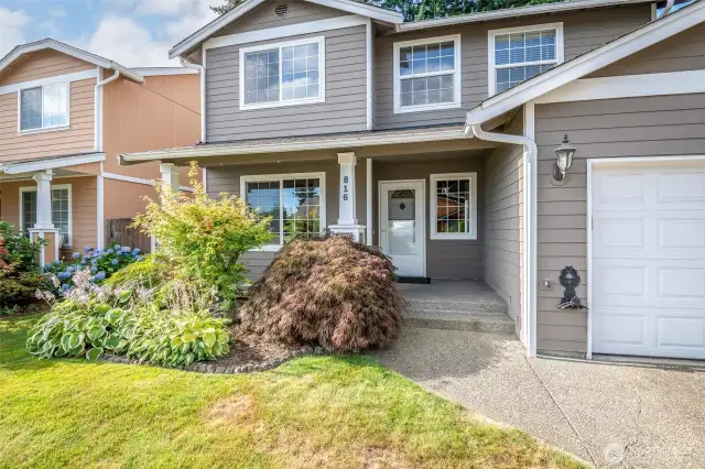 Covered front porch with beautiful front garden space