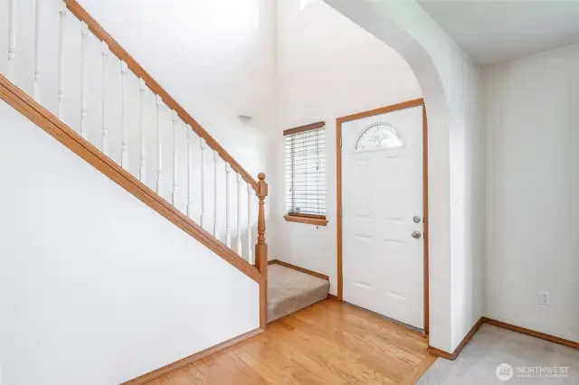 Front entry with high ceilings to the upstairs with large statement light.