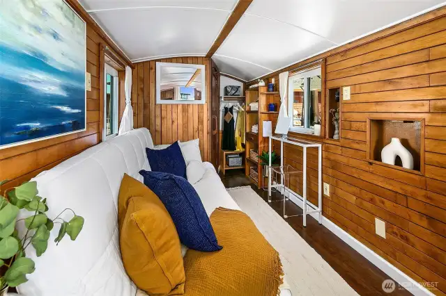 The captain’s quarters offer a restful retreat, with rich wood paneling, built-in storage, and double-pane windows bringing in natural light and fresh air from the marina.