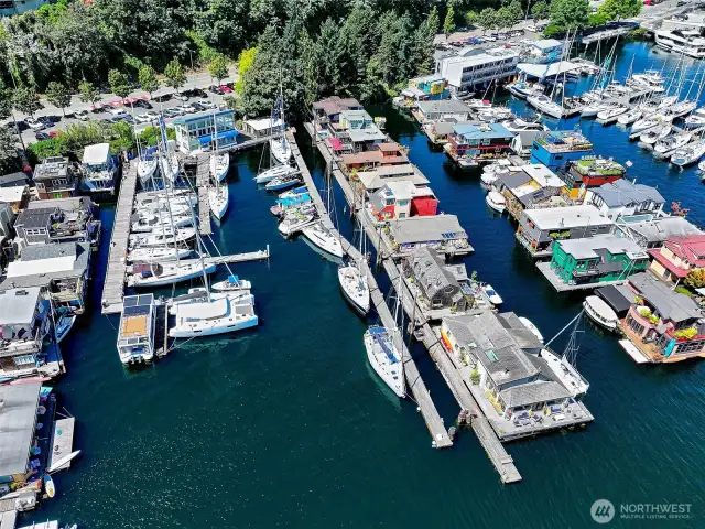 From above, Boatworld Marina stretches along Westlake’s shoreline, a vibrant mix of yachts, floating homes, and city-meets-water living — with the S.S. Guppy at the heart of it all.