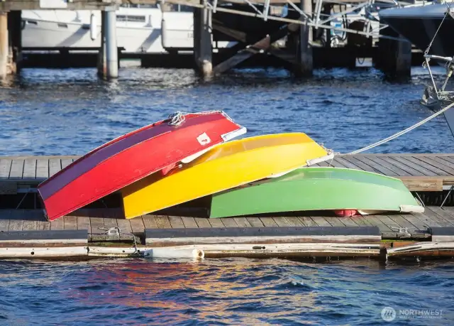 Brightly painted kayaks rest along a Lake Union dock, ready to launch into the city’s most accessible stretch of water — just steps from the S.S. Guppy’s moorage.