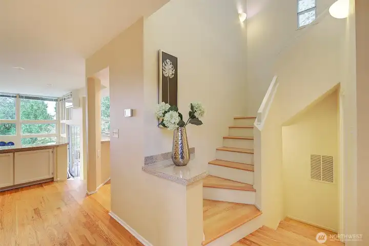 Light-filled entry with hardwood floors.