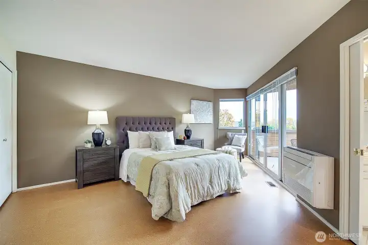 Spacious primary bedroom with view deck, 5 piece bath and 2 closets.