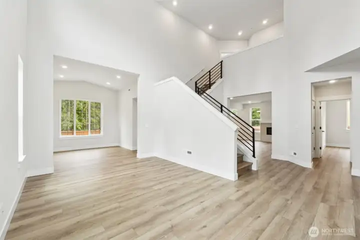 Look at all that light coming through all the windows.  LVP flooring throughout entire main floor, at stairs and upper hallways. Pic of similar home, colors and materials may vary