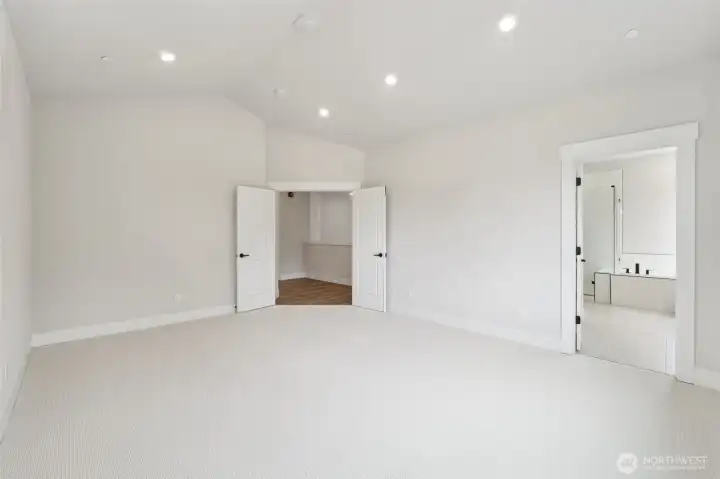 Primary bdrm. Is very spacious & can fit large furniture.  Vaulted ceilings w/can lighting and prewired for ceiling fan or chandelier.  Pic of similar home, colors and materials may vary