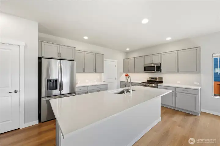 Center island with sink and eating bar for casual meals.