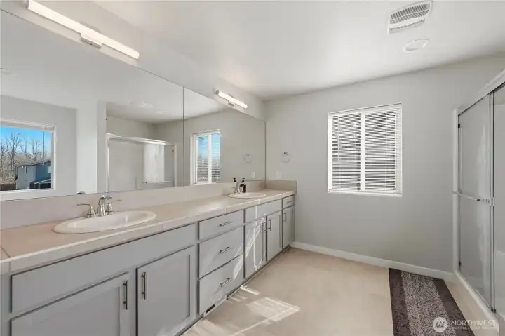 Spa-like primary bath with dual sink vanity.