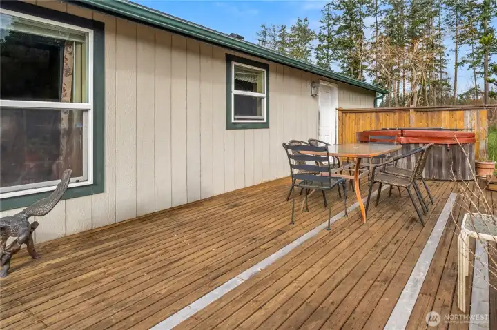 The deck with hot tub, the door leads to the utility room adjacent to the kitchen.