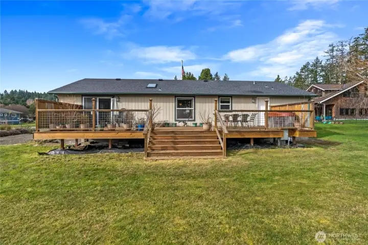 The back of the house showing the spacious deck. The back of the house showing the spacious deck.