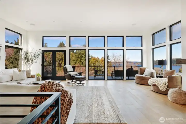 Upper living area where lake, light, and living spaces blend. The deck faces north.