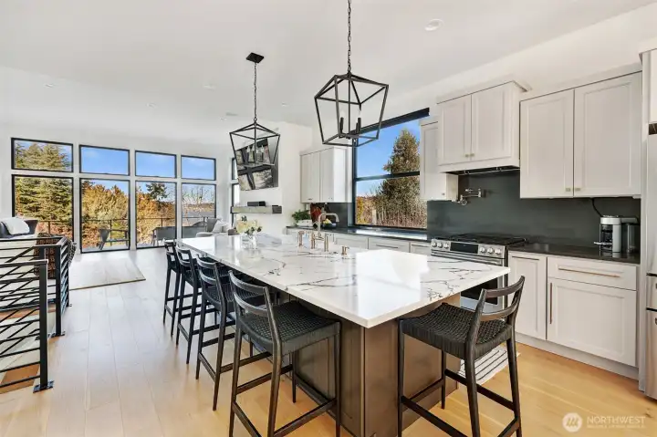 Gather around the 5-seating island or congregate in the dining room to the right of his photo.