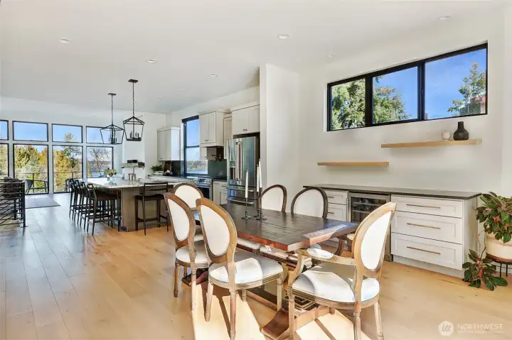 Dining room exposing beautiful natural light coming through the foyer windows. The south facing deck is accessed to the right of this photos and is perfect for those summer days.