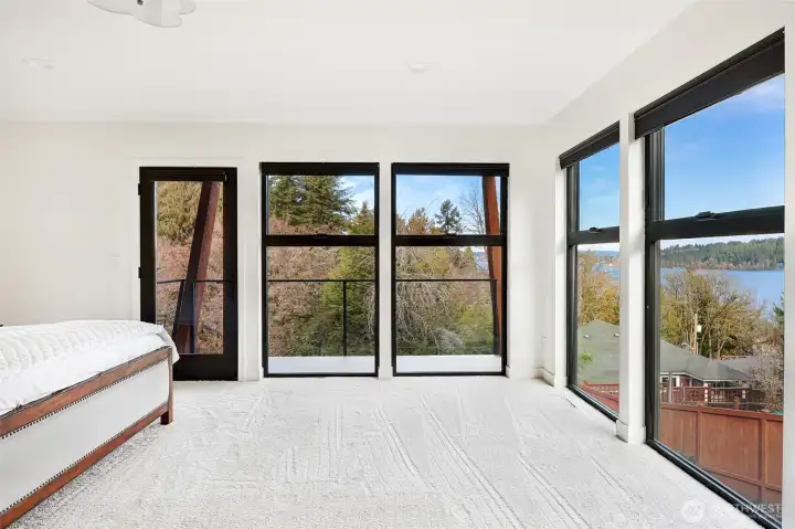 Expansive primary ensuite on the main level of the home with gorgeous views on your private balcony.