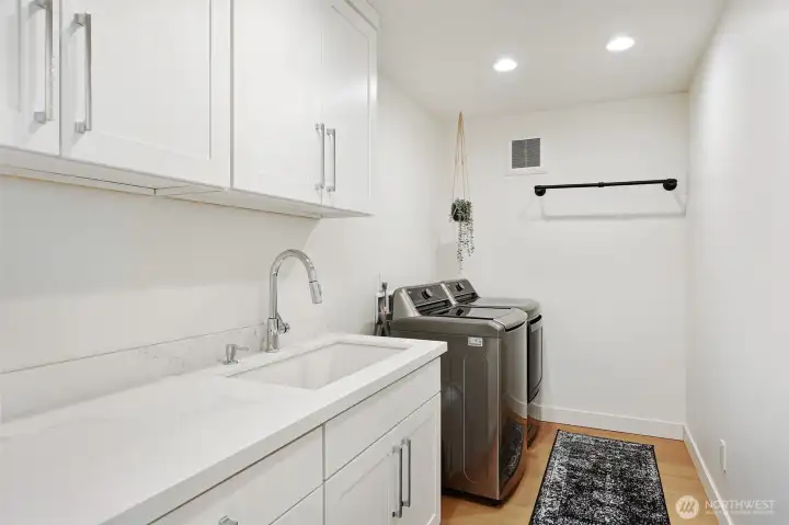 Main level dedicated laundry room. This room is on the same level as the primary bedroom and second bedroom with ensuite.