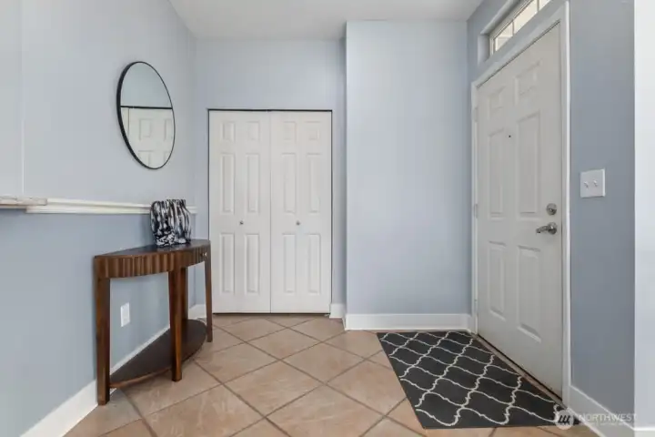 Nice entryway with tile floor and coat closet