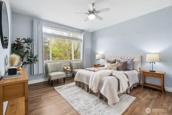 Spacious primary suite with ceiling fan/light