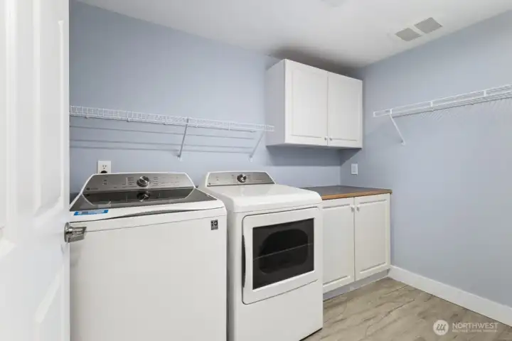 Real laundry room with storage space and hanging rack