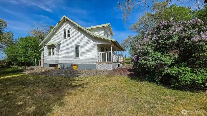 West side of the home. The whole property is filled with beauty and space.