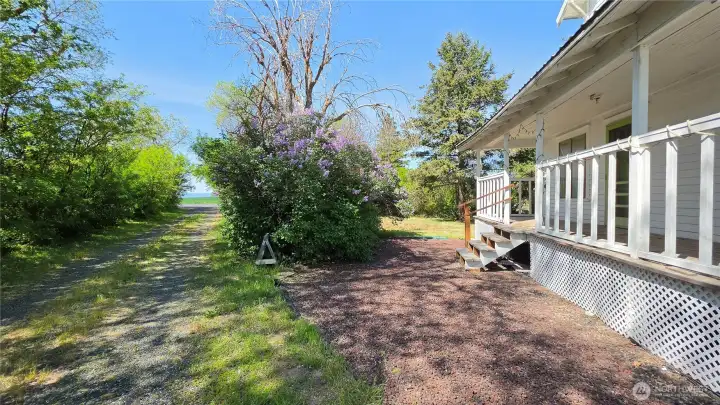 Looking SW from the driveway. This covered deck is perfect for BBQ's and entertaining.