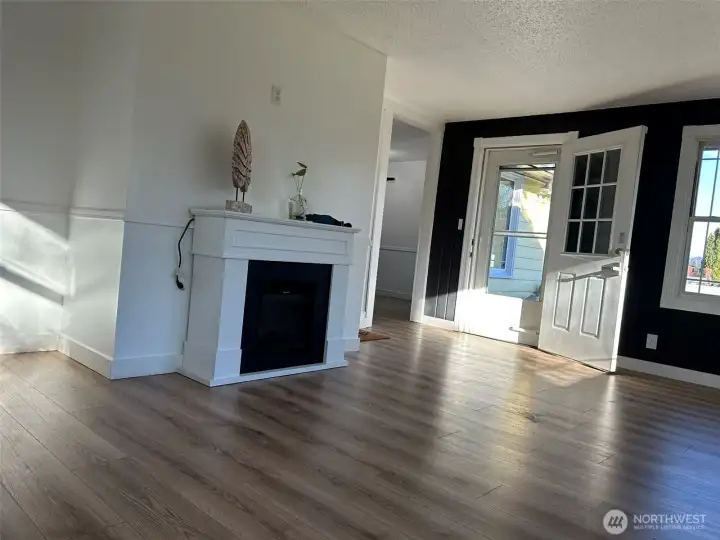 Gleaming hardwood floors and cozy fireplace makes you feel relax in the living room