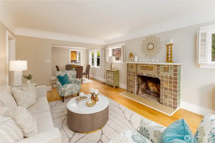 Gracious living and dining room areas feature picture moldings, rich hardwood floors, and the original, tiled fireplace.