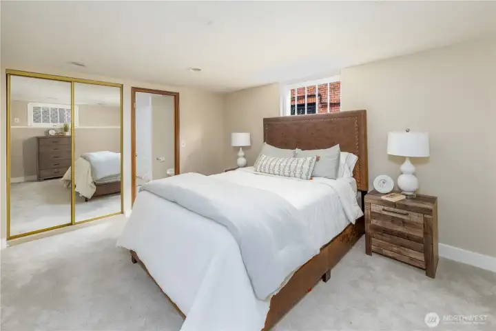 Lower level with high ceilings features a large bedroom with a wall of closets and full bath.