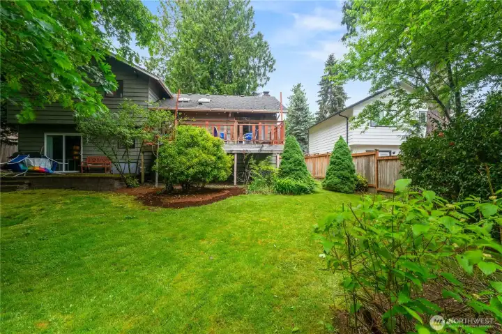 Expansive backyard with mature landscaping and plenty  of room to relax, garden, or play.