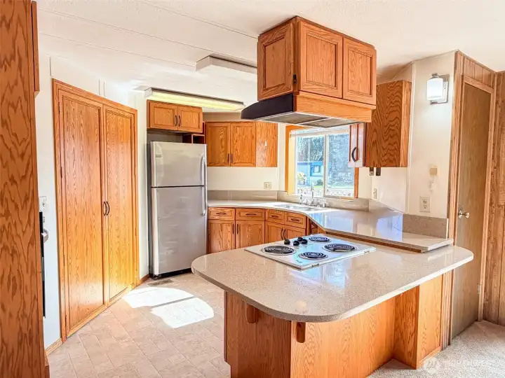 This kitchen features stainless steel appliances, ample storage, generous countertop space, and a convenient breakfast bar for casual dining.