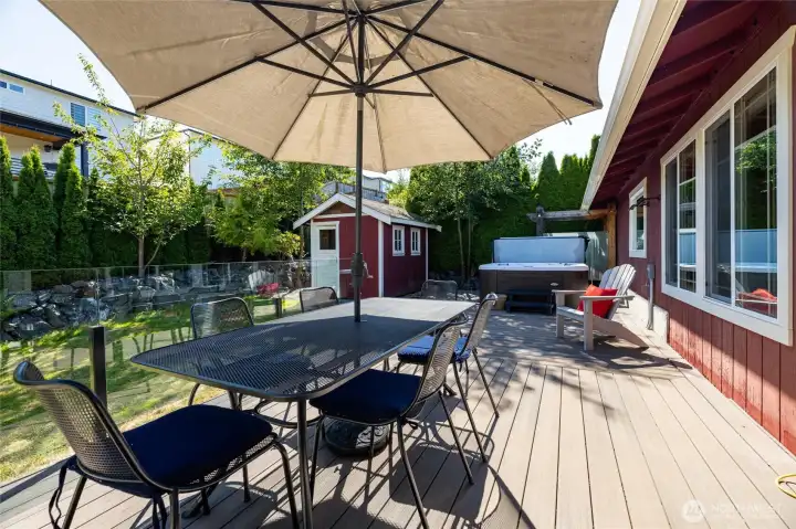 Huge composite deck with high end glass railings, a brand-new hot tub, and an outdoor shower. Huge composite deck with high end glass railings, a brand-new hot tub, and an outdoor shower.