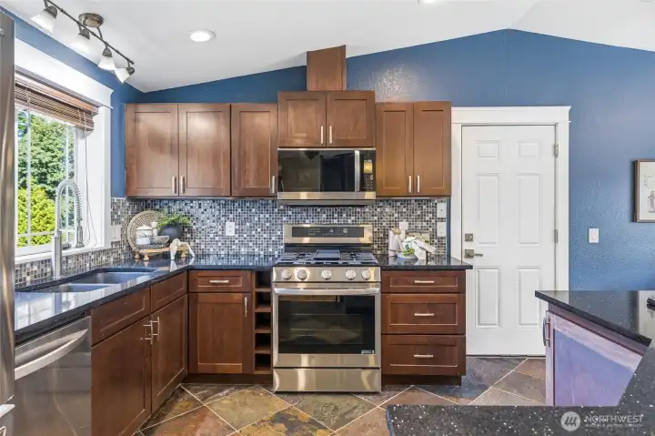 Heated flagstone floors, brand new kitchen appliances, beautiful cabinetry, title backsplash, and granite countertops. Heated flagstone floors, brand new kitchen appliances, beautiful cabinetry, title backsplash, and granite countertops.
