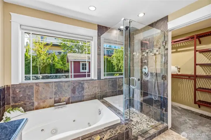 Custom built flagstone and stone/pebble walk-in shower completely surrounded by pristine glass. Custom built flagstone and stone/pebble walk-in shower completely surrounded by pristine glass.