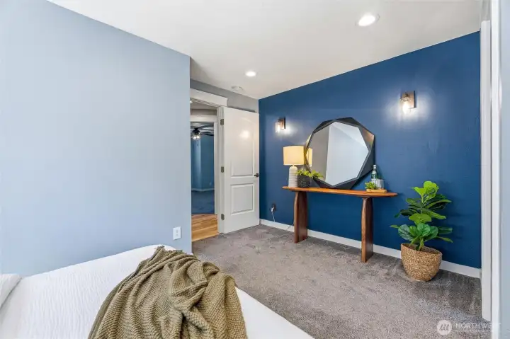 The primary bedroom is located at the end of the hall, and the two guest rooms are right across the hall. The primary bedroom is located at the end of the hall, and the two guest rooms are right across the hall.