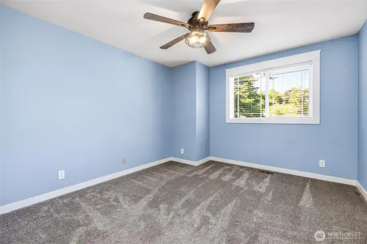 Guest bedroom #1 is directly across from the primary bedroom and has newer carpet, trim, paint and a ceiling fan. Guest bedroom #1 is directly across from the primary bedroom and has newer carpet, trim, paint and a ceiling fan.