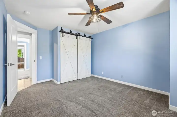 The closet features newer barn style sliding doors. The closet features newer barn style sliding doors.