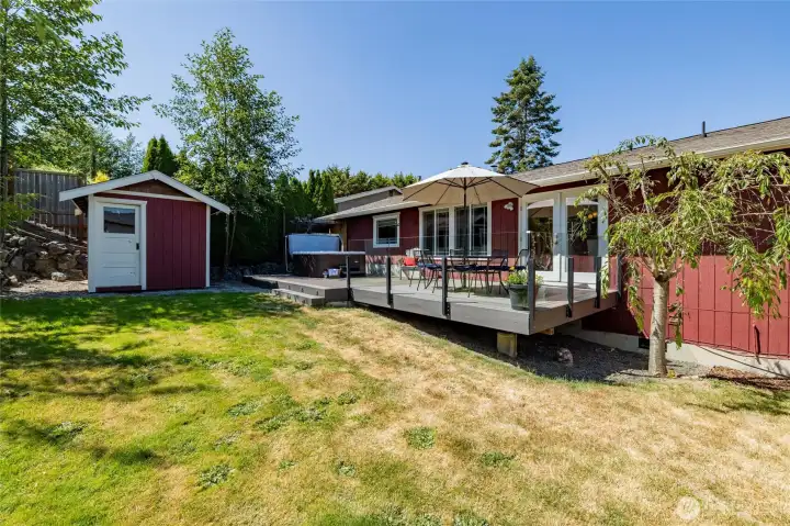 The private backyard is mainly fenced (just need to add a gate) and features a garden shed, huge deck, hot tub, and outdoor shower. The private backyard is mainly fenced (just need to add a gate) and features a garden shed, huge deck, hot tub, and outdoor shower.