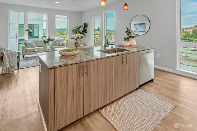 A sprawling island adds both functionality and elegance, connecting the living area to the dining room and extending to the private balcony.