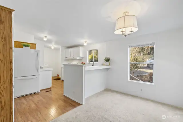 Dining room area with additional kitchen seating at the counter.