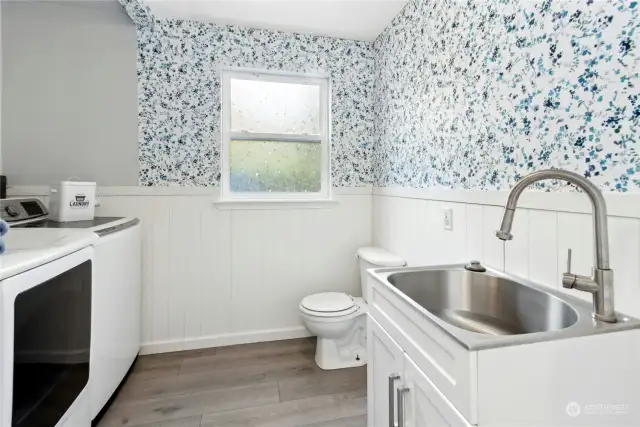 Perfect utility room, tucked by garage access and additional outdoor access.