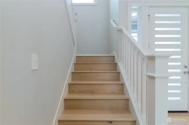 Stairs at entry foyer leading to upper level of home.