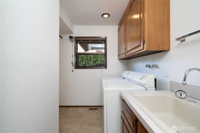 Laundry room with utility sink. Washer and Dryer stay.