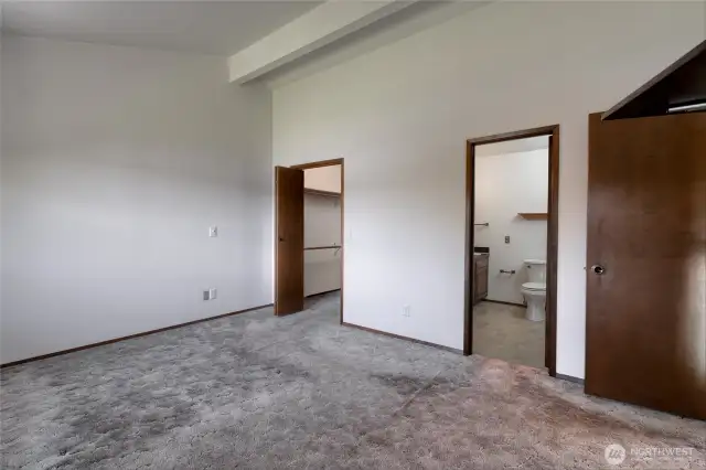 Upstairs primary bedroom looking toward closet and bath.