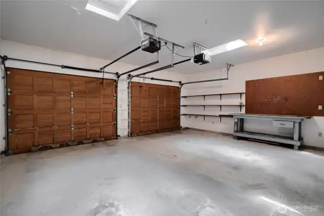 Two car attached garage with workbench.