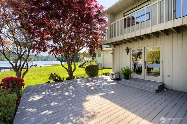 French doors off dining, primary balcony above.