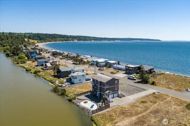 Waterfront home near beach - showing Admirals Cove Clubhouse & Pool in upper left corner and vacant lot to the W of the home.