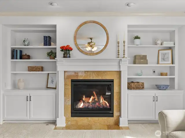 Cozy gas fireplace complemented by built-in shelving and additional storage.